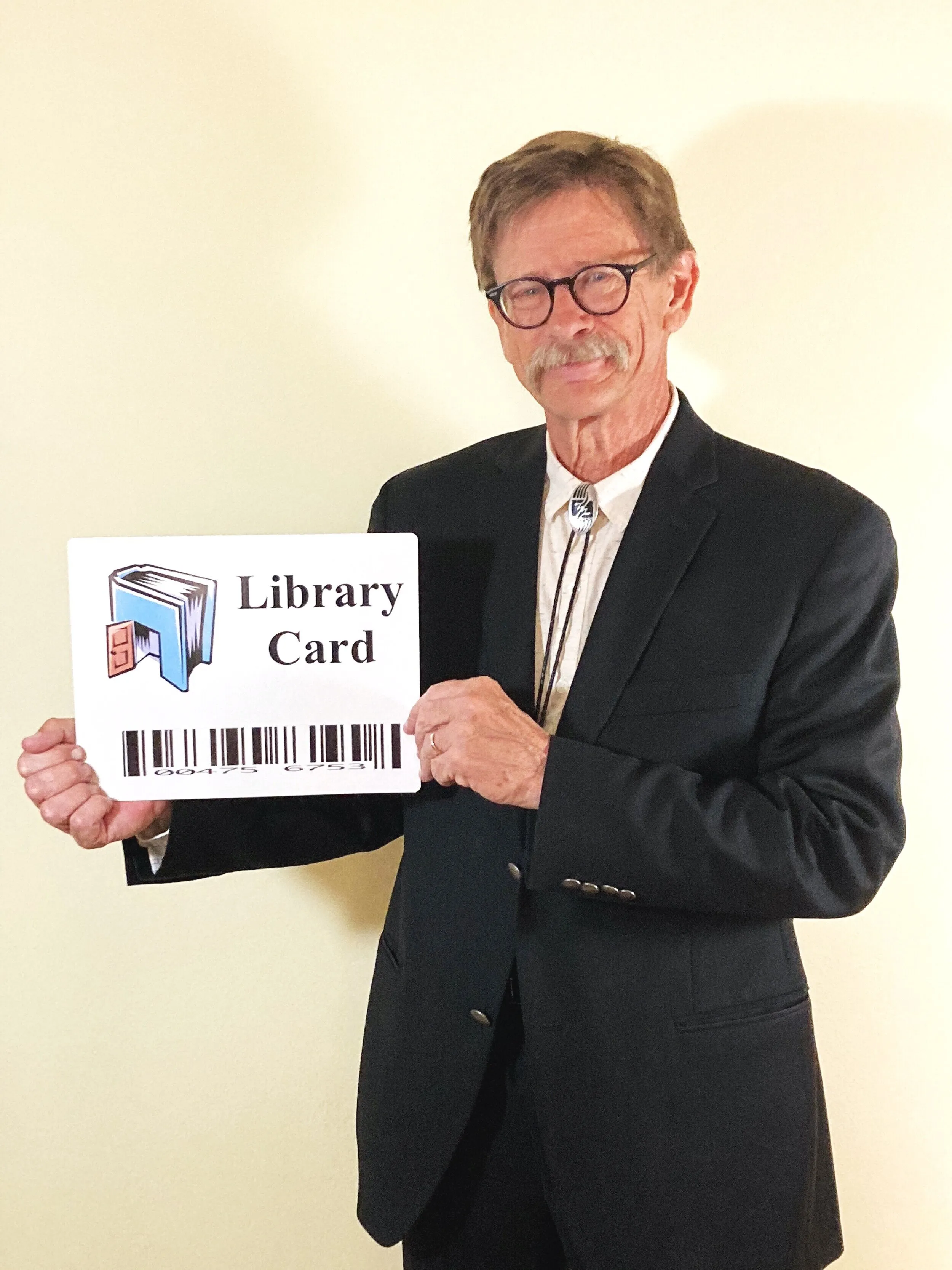 Cody Landstrom holding up a giant library card