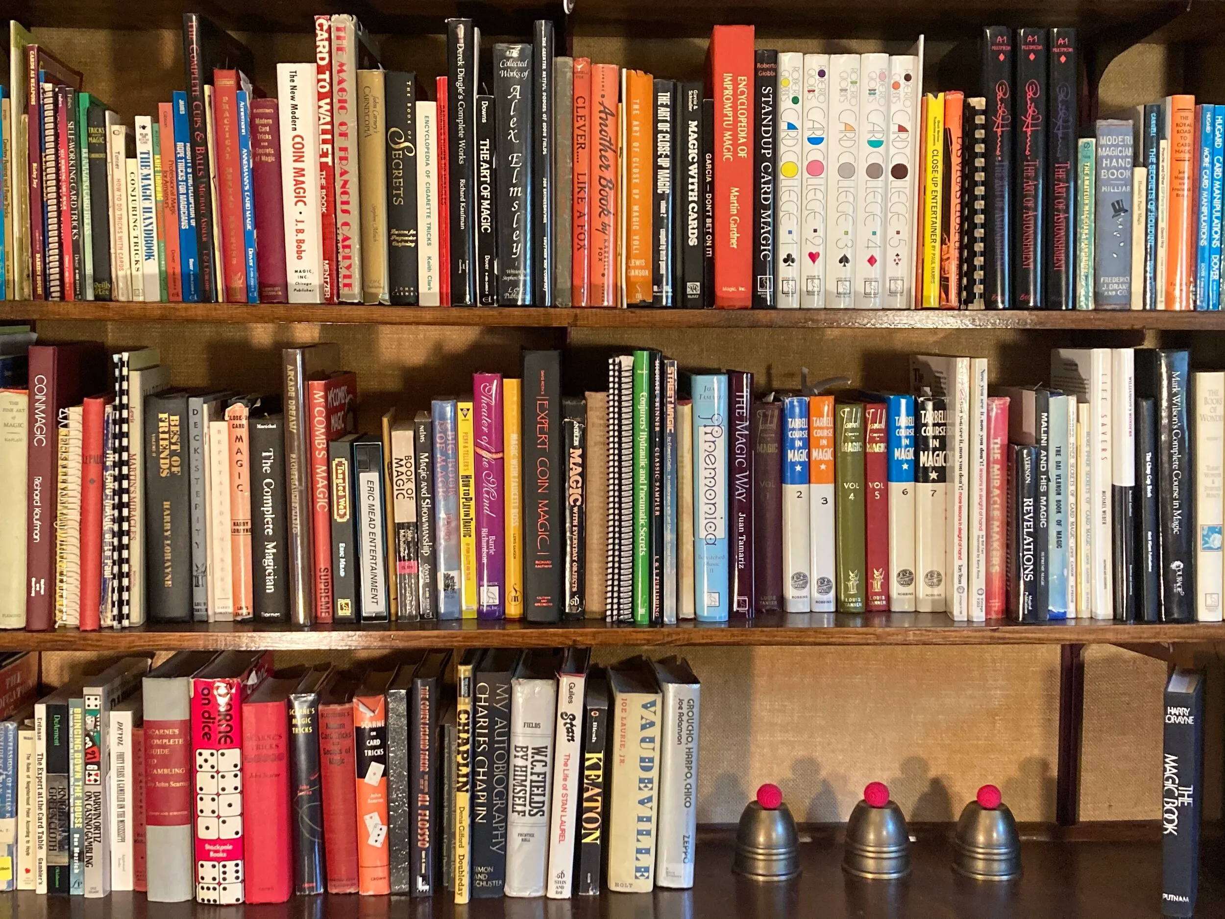 Shelves of magic books with three cups and balls